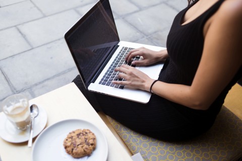 Cropped image of modern businesswoman work in internet via net-book while resting in cafe outdoors, young female keyboarding on laptop computer with blank empty screen for your information or content