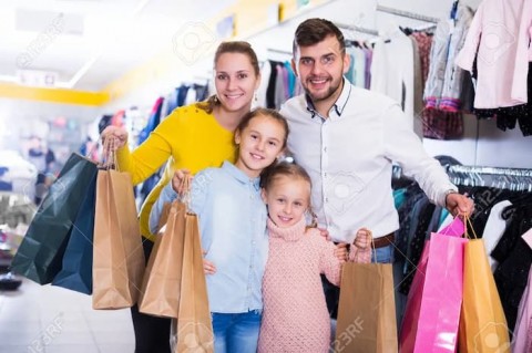 101617628-portrait-of-happy-family-of-four-with-shopping-bags-in-clothing-shop